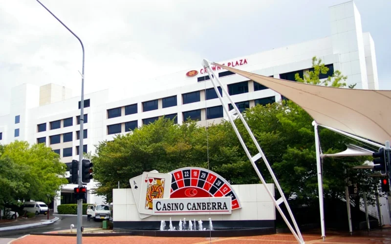 The main entrance to the Canberra Casino grounds with the name and roulette wheel depicted on the stand.